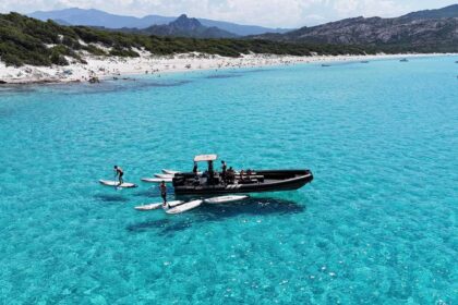 Plage de sable blanc et eau turquoise peu profonde adossée au maquis, sur la côte nord de la Corse